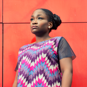 Behind the Magic - Jemimah Ugen Chigi's World BTM Interview Singer Songwriter Fashion Designer Lifestyle Blogger Ankara African Print Dress White Sneakers Natural Hair Curls Princess Leia Bun